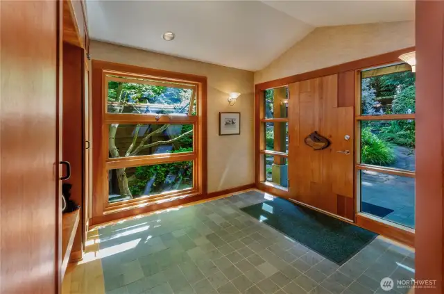slate entry features a massive sold wood front door