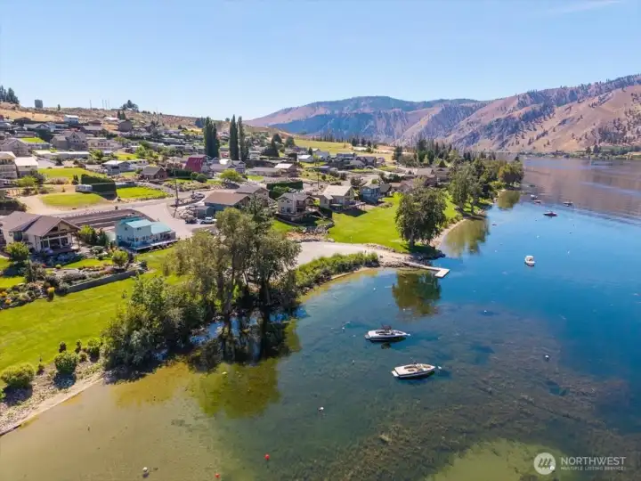 Aerial view of community waterfront w/ boat launch and dock.