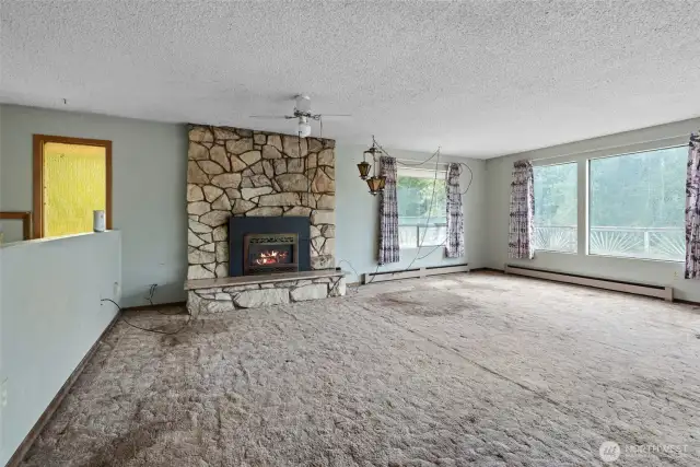 Fireplace highlights the upper-level living room — bring your creativity, the potential is endless.