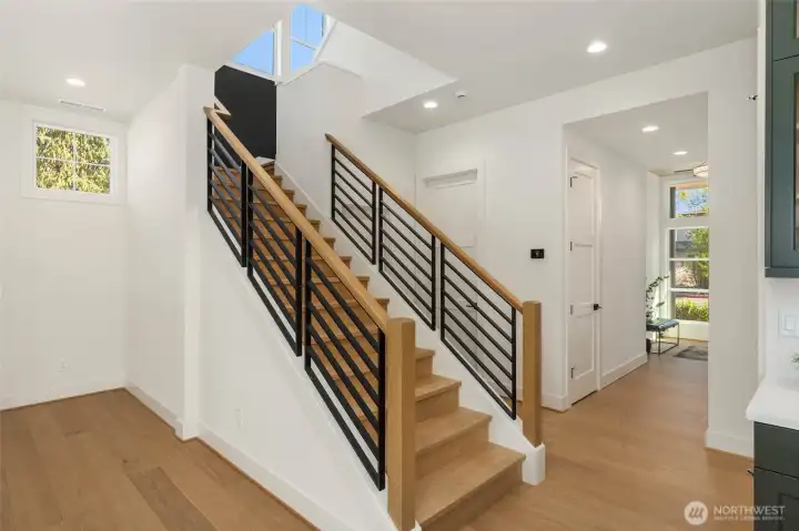 Beautiful wood staircase with wood /iron railing.