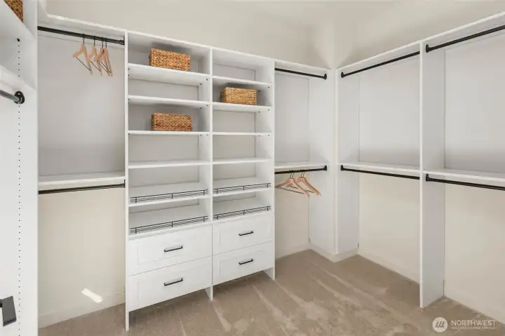 Spacious primary closets with build-in shelving and drawers.