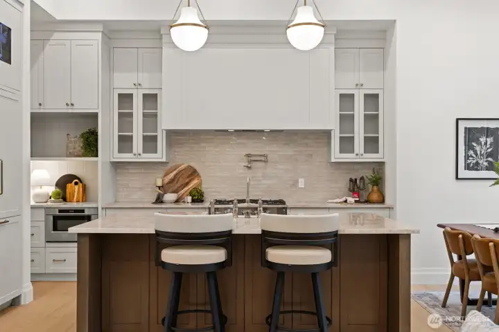 The materials elevate the experience of true luxury with continuous Taj Mahal Quartzite countertops, wide-plank European Oak flooring, custom white oak doors and millwork, designer lighting, and premium hardware.