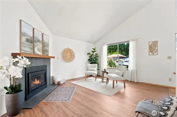 Cozy living room with abundance of natural light, and a modern gas fireplace for chilly days.