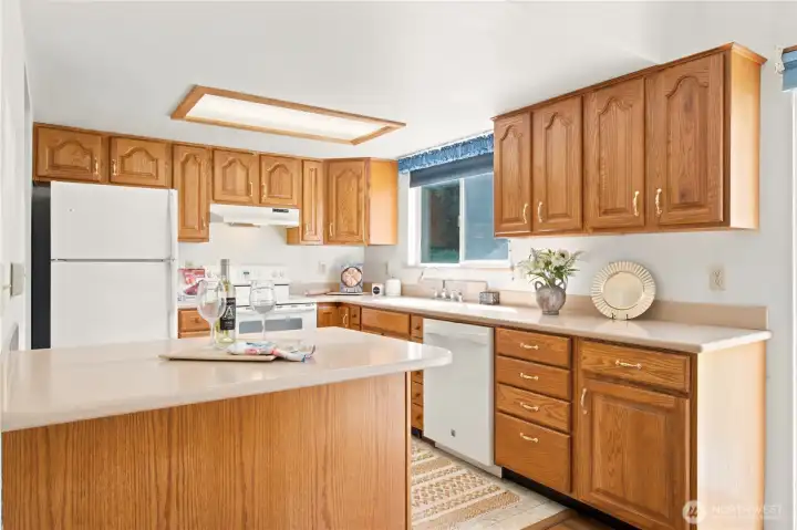 Spacious kitchen with Corian countertops and farm kitchen sink