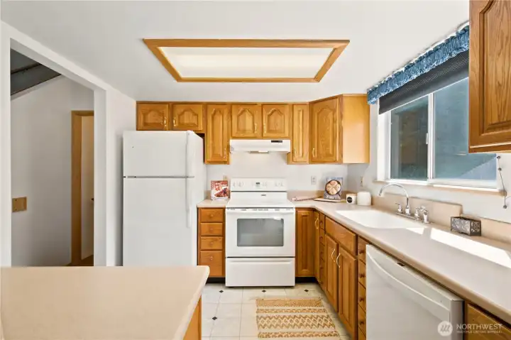 Spacious kitchen with Corian countertops and farm kitchen sink