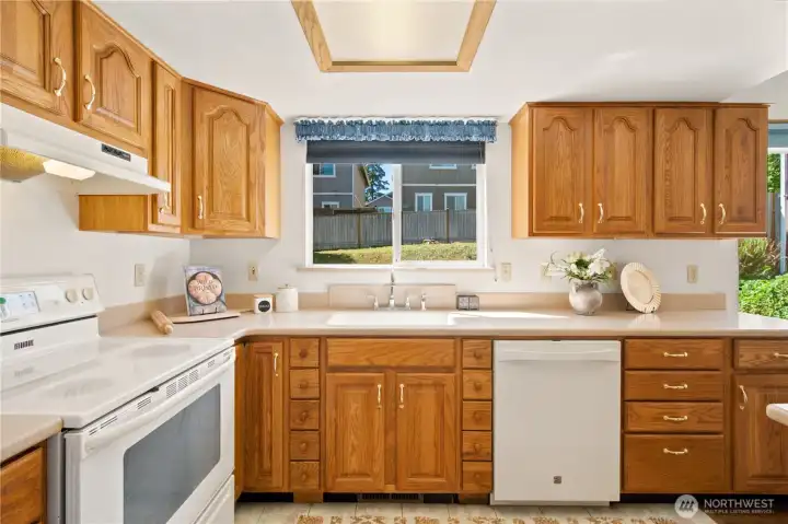 Spacious kitchen with Corian countertops and farm kitchen sink