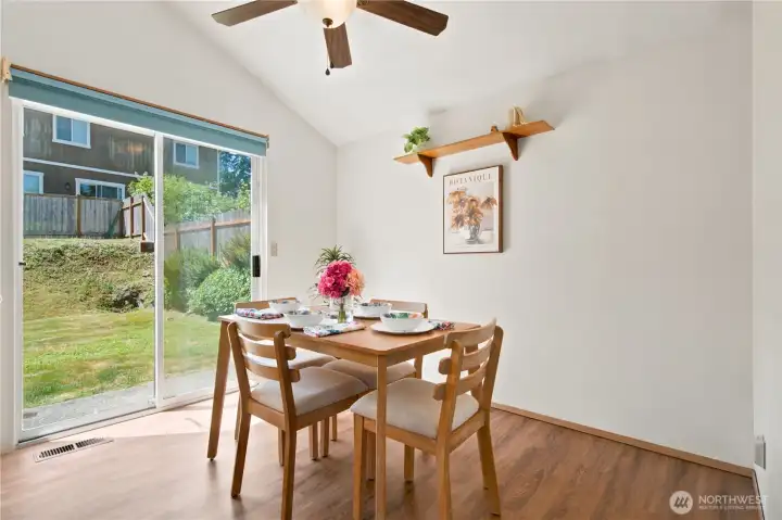 Dining Room, vaulted ceilings, ceiling fan and step out to fully fenced back yard - convenient for BBQ's
