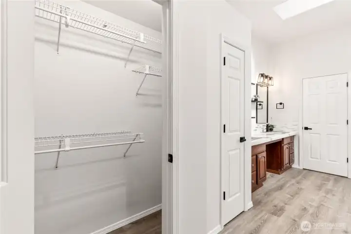 Primary bathroom entrance and "his" closet