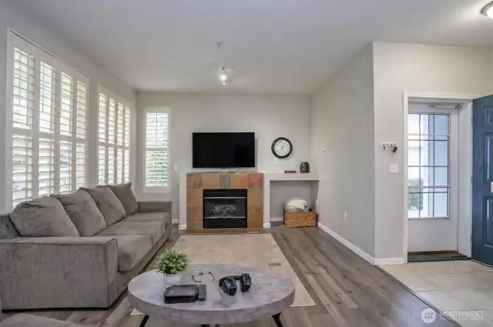 Welcome home—beautiful shutters and an electric fireplace create a warm, inviting space that instantly feels like home.