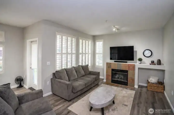 Another view of the living area, featuring a glass door to the left that opens to the covered patio.