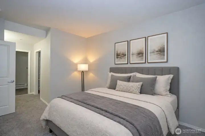 Alternate view of the primary suite highlighting its spacious, light-filled design.
