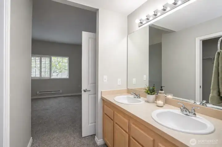 Primary ensuite featuring dual sinks and ample counter space for added convenience.