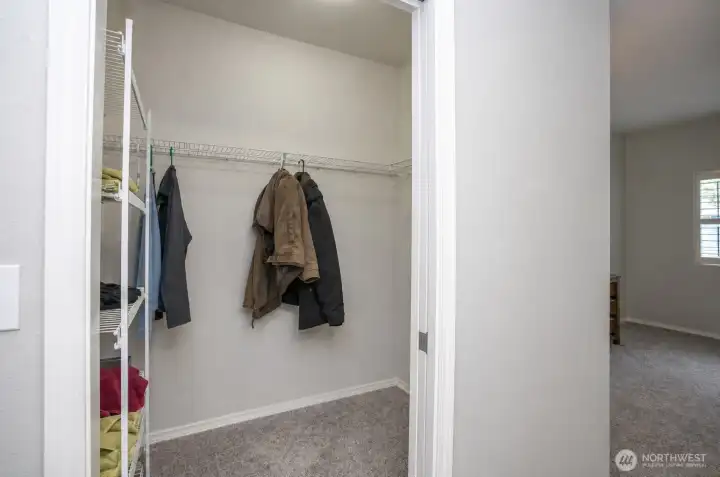 Generous walk-in closet in the primary suite offering excellent storage and organization space.