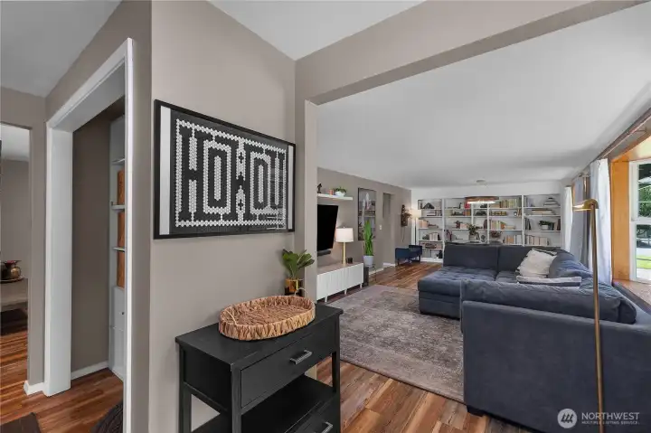 Great flow! Huge living space to the right with built in cabinetry, tucked away drop zone directly off entry, with kitchen/2nd living space access to the left.