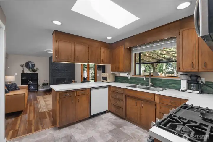 Welcome to your bright and airy kitchen with skylight with direct access to 2nd living space, gas fireplace, and covered back patio. Great indoor/outdoor living!