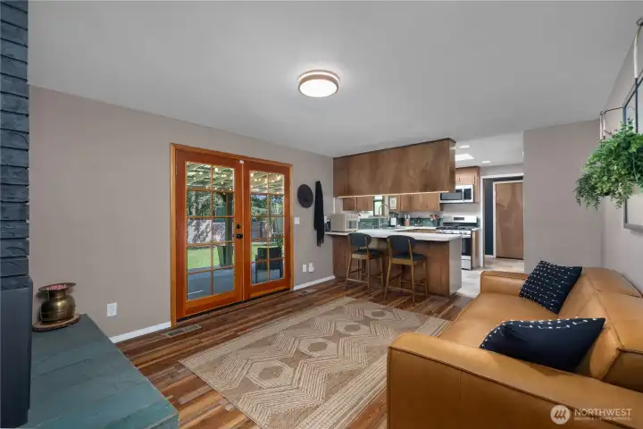 View from gas fireplace looking towards kitchen. Notice the convenient access through french doors to covered back patio.