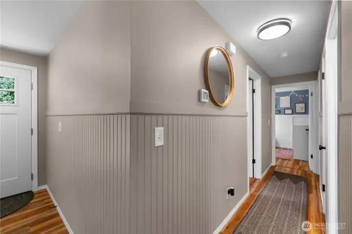 View down hallway and towards front door. Notice new hallway lighting.