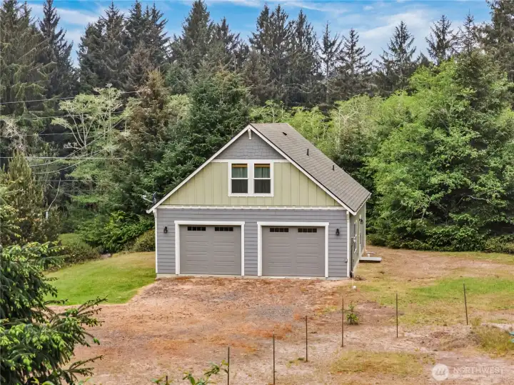 Spacious garage with living space above set on a large level lot surrounded by Pacific Northwest greenery and your own private path to the Willapa Bay.