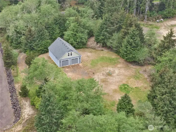 Elevated aerial perspective showcasing the private setting surrounded by Pacific Northwest trees and open space.