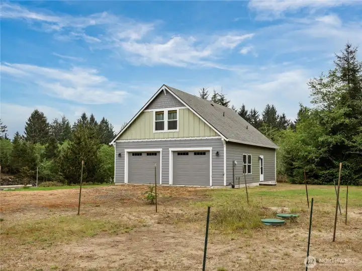 Single family home with large garage positioned on a generous property with room for equipment, hobbies, or future use.