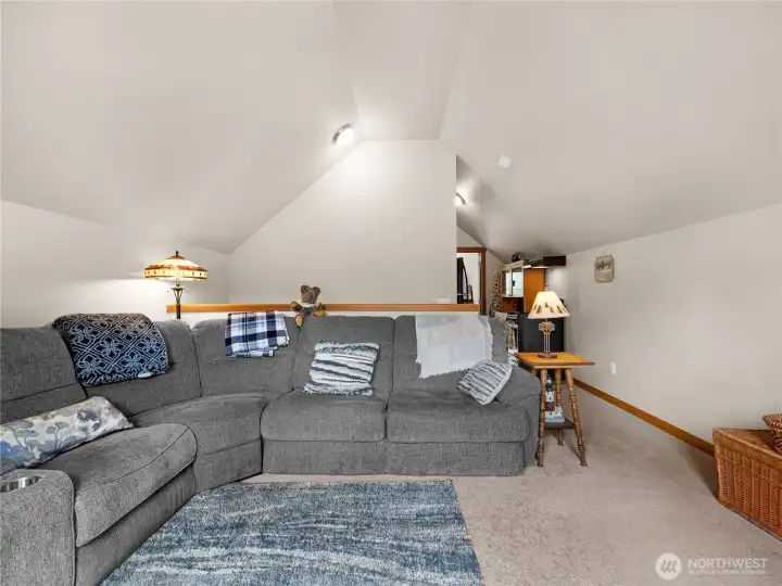 Open-concept upper loft area offering flexible living, office, or recreation space.
