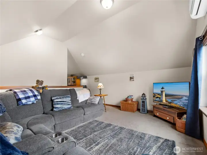 Spacious loft with vaulted ceilings, neutral finishes, and plenty of natural light.
