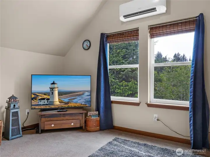 Large picture windows bring natural light and peaceful territorial views into the loft living area.
