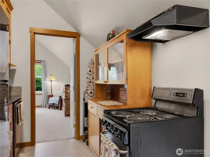Functional kitchen area featuring warm wood cabinetry and efficient workspace.