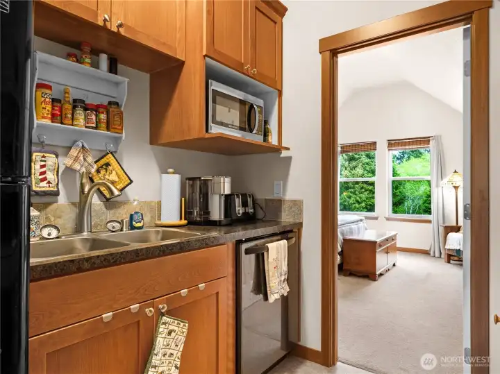 Kitchen with built-in storage and easy flow into the adjacent living space.