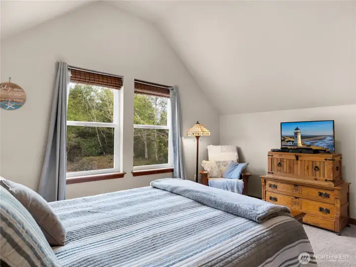 Large bedroom retreat featuring oversized windows and a bright, airy feel.