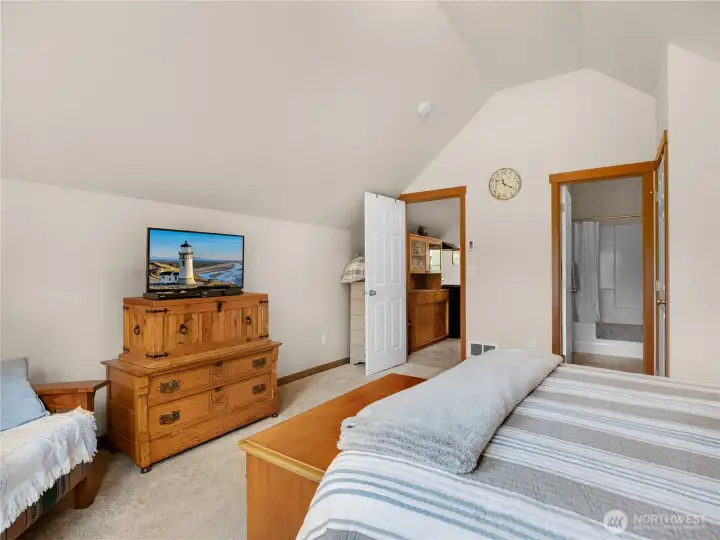 Comfortable bedroom space with vaulted ceilings and flexible furniture arrangement options.