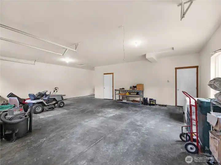 Expansive garage interior offering versatile space for recreational equipment, workspace, or additional storage.