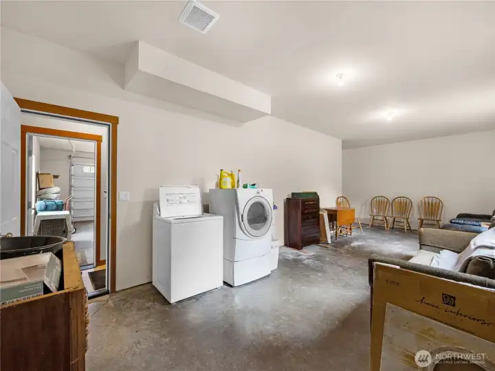 Functional lower-level space with laundry area and flexible use potential.