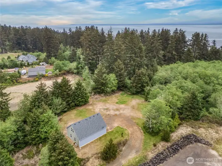 Bird’s-eye view of the property’s expansive lot, detached structure, and peaceful Ocean Park setting on the Willapa Bay.