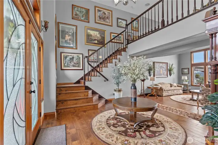 Double door grand entry with 1 of 2 staircases in home