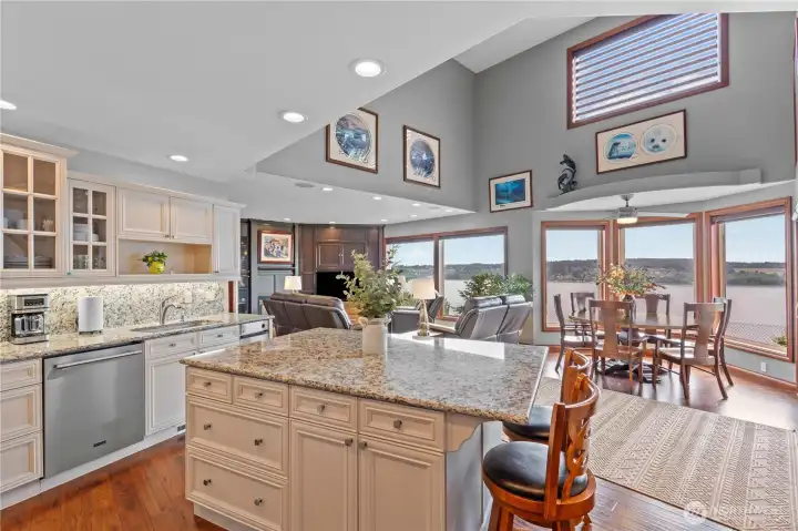 Kitchen looks out to view, eating area and family room