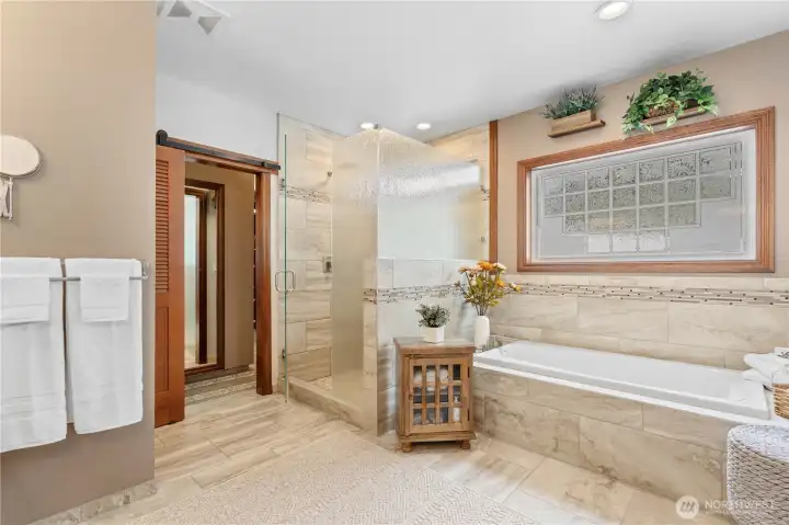 Soak tub, beautiful shower and walk-in & walk-around closet straight ahead