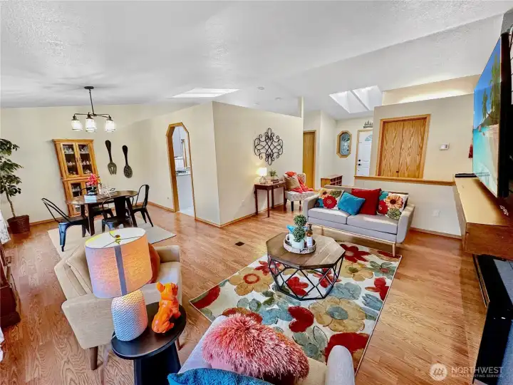 In this photo to see the entry, living room and dining area. You will love how the vaulted ceilings and skylights offer so much natural light throughout the rooms. In this photo to see the entry, living room and dining area. You will love how the vaulted ceilings and skylights offer so much natural light throughout the rooms.