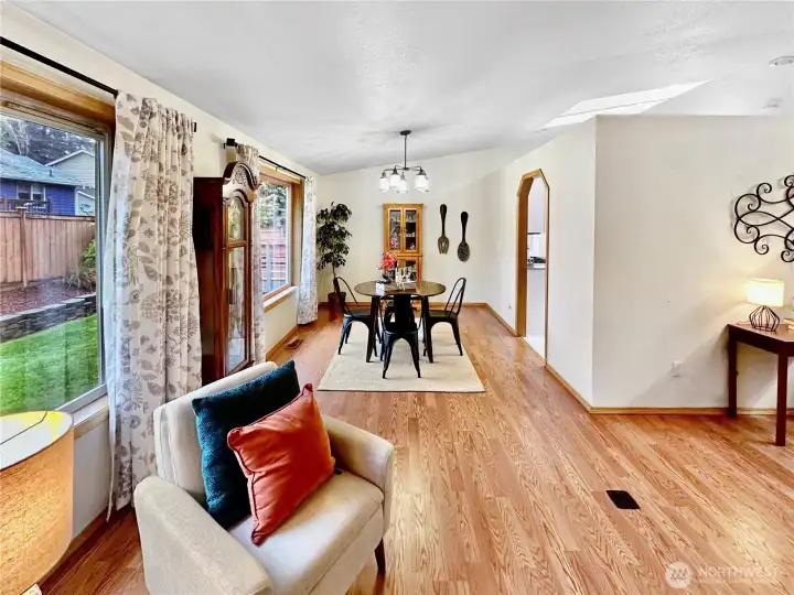 This shows the vaulted dining room featuring laminate floor and new light fixture. This shows the vaulted dining room featuring laminate floor and new light fixture.