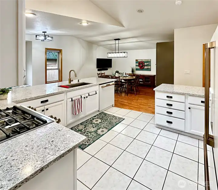 Beautiful updated kitchen with white cabinets, new quartz counters, new white appliances including the gas cook top range. Beautiful updated kitchen with white cabinets, new quartz counters, new white appliances including the gas cook top range.