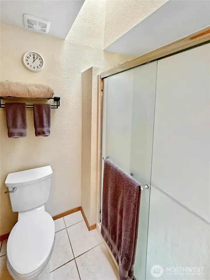 Sky-lighted primary bath shower and toilet area. Sky-lighted primary bath shower and toilet area.