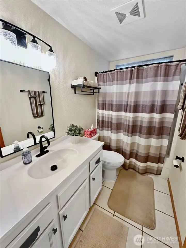 The updated hall bath with new counter/sink and new light and towel fixtures. The updated hall bath with new counter/sink and new light and towel fixtures.