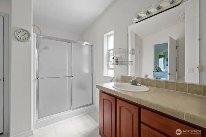 Primary bathroom accessed from bedroom and laundry