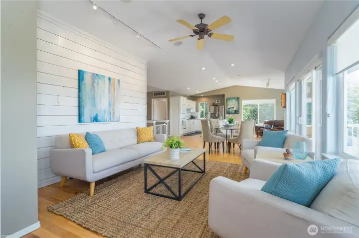 Looking from the family room towards the dining area.  Family room has Classic Shiplap on the wall.  Hardwood floors, lots of windows looking West.