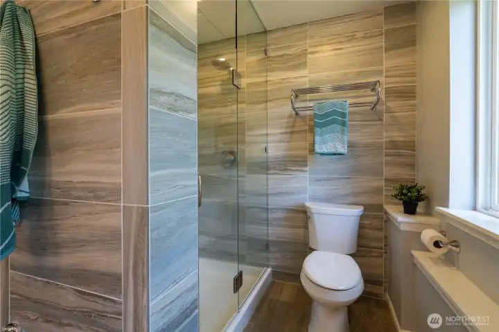 Lovely downstairs bathroom with walk in shower.  Tile surround with glass shower door.