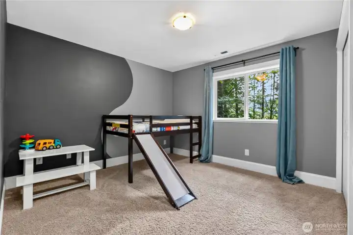 Downstairs bedroom with forest views.