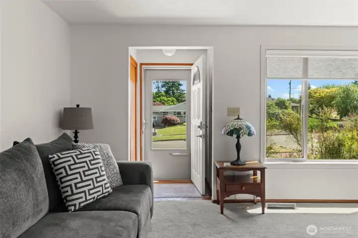 Looking from the comfort of the living room toward the entryway, this angle showcases a seamless flow and a bright, welcoming transition that greets you the moment you step through the front door. Looking from the comfort of the living room toward the entryway, this angle showcases a seamless flow and a bright, welcoming transition that greets you the moment you step through the front door.