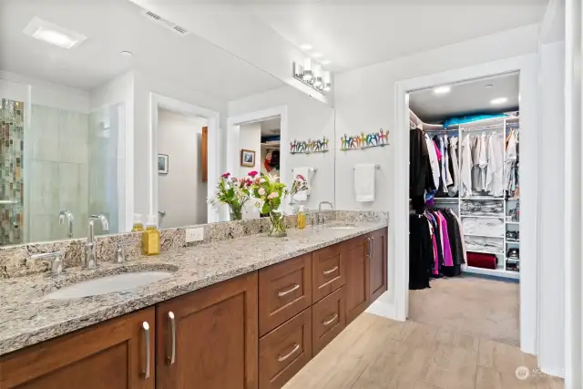 Primary bath with Quartz counters, heated tile floors & floating vanity with dual sinks