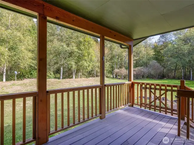 Cover back porch to relax and take in the sounds of the Little Quilcene River.