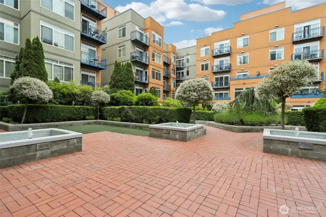 Community Courtyard with paved walking path plus fountains